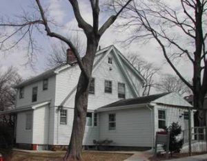 Coder House in Winter with bare trees in front