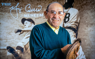 Yogi Berra holding catcher's mitt.