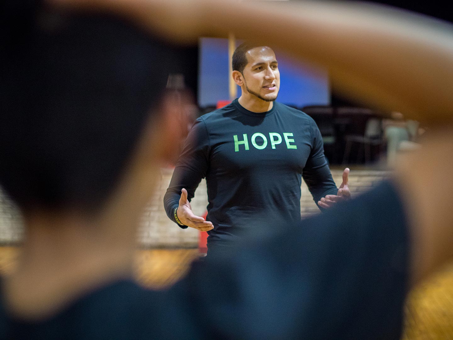 Photo of Gian Paul Gonzalez coaching kids.