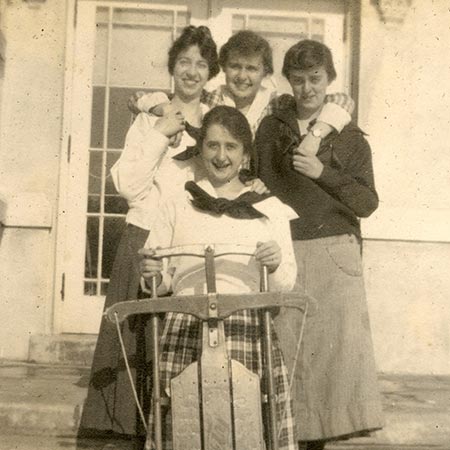 Black and white photo of three girls posing after coasting.