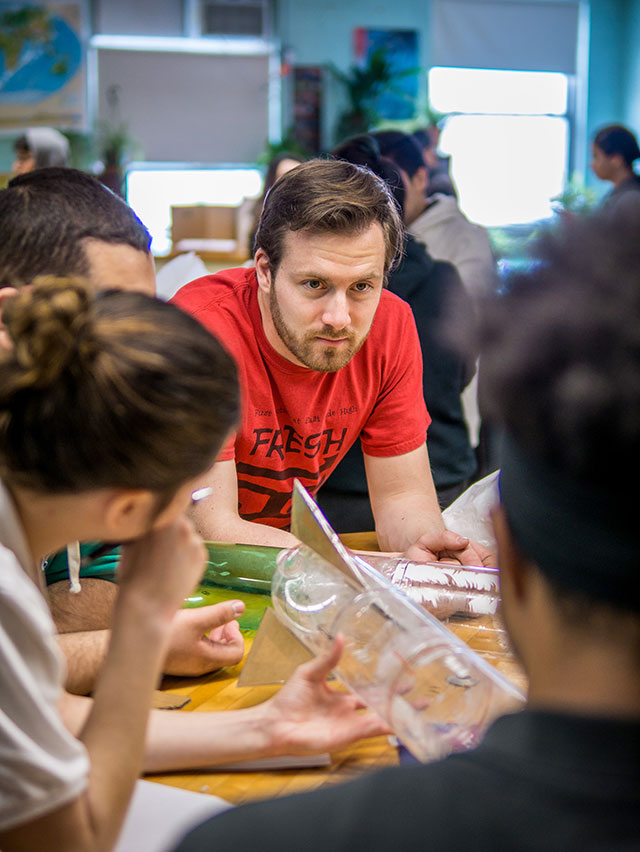 Biology teacher Dave Koethe speaking with students.