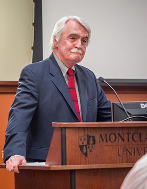 Photo of Gregory Waters speaking at podium.