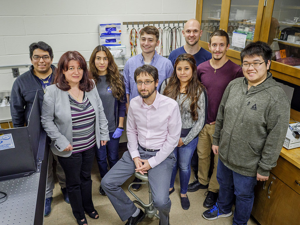Martin and Favata and their students Kevin Santiago, Avendano, Nicholas Provost, Lita de la Cruz, Matthew Karlson (back), Joseph DeGaetani and Kevin Chen who are helping the LIGO team “listen to the universe.”