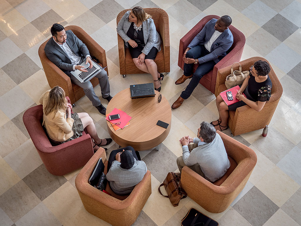 Students sitting around table in armchairs in CELS