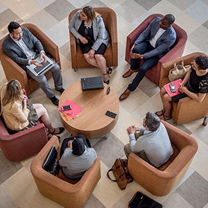 Students sitting around table in armchairs in CELS
