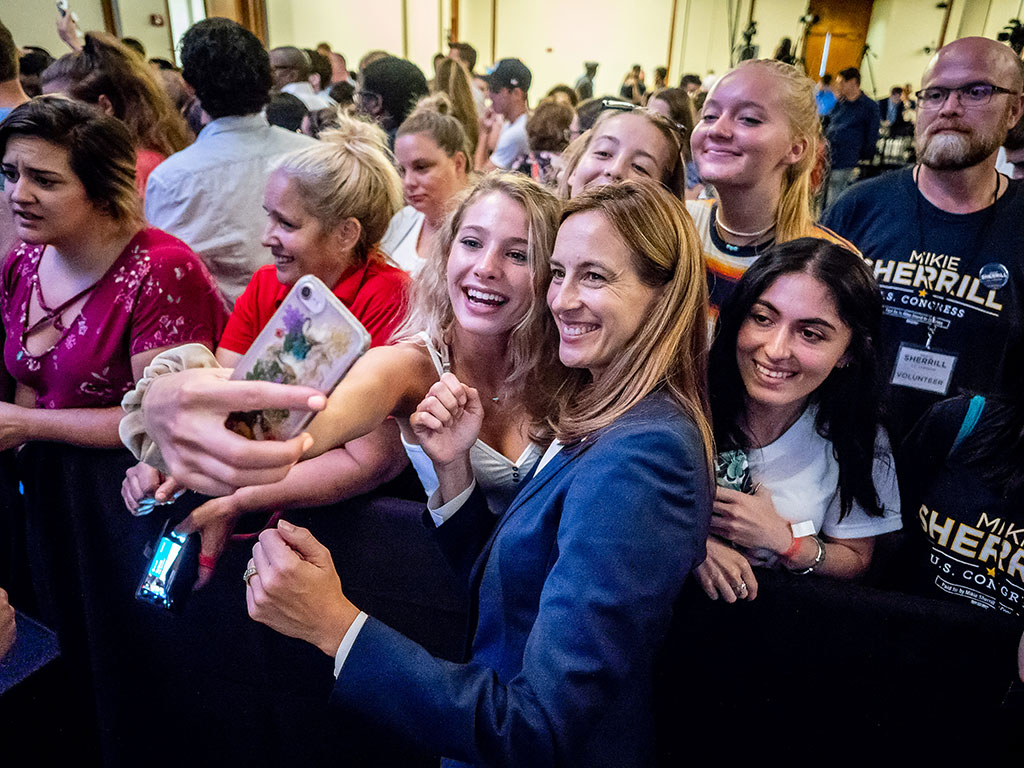 Biden and then congressional candidate Mikie Sherrill pose with students