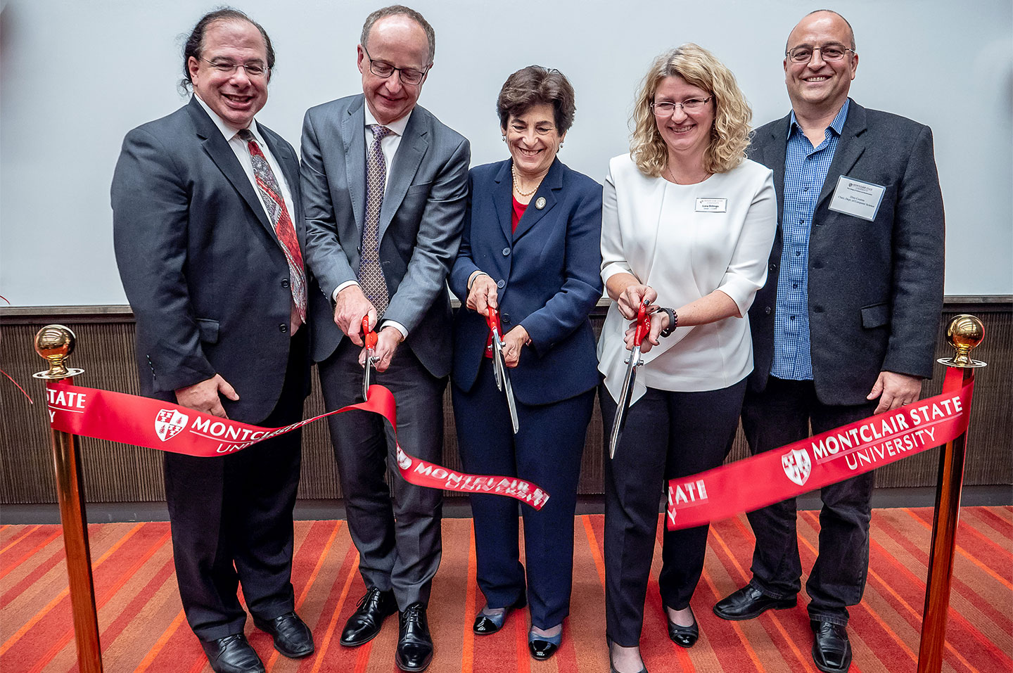 Alumnus Anthony Scriffignano ’82, ’85 MA and University board member Francis Cuss join Susan A. Cole, Lora Billings and Constantine Coutras at the opening