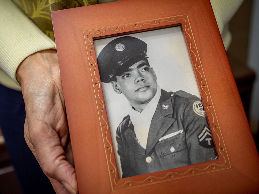 Deborah Fish Ragin holds a photograph of her father, John A. Fish, who spent part of his childhood in foster care.