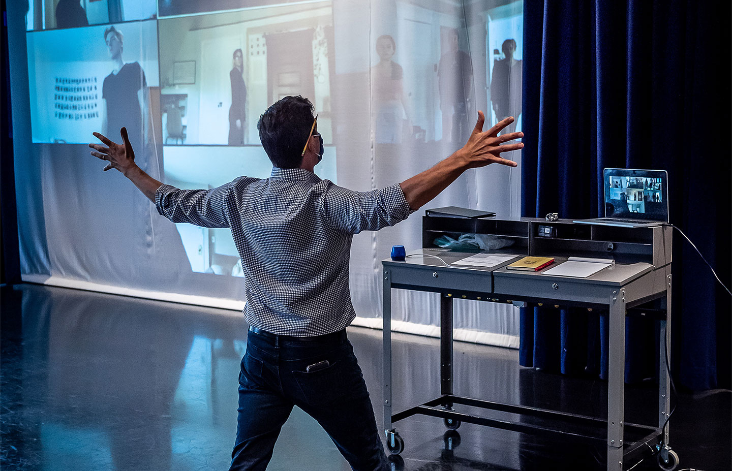 CART professor with hands outstretched giving Zoom class