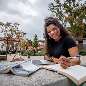 Female student writing in notebook