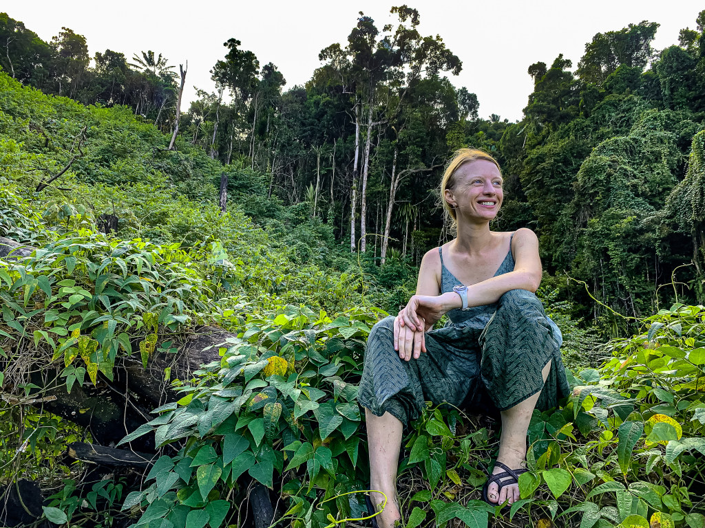 Borgerson sits in a garden of tsidmy, the lima bean plant that the bacon bugs are drawn to.