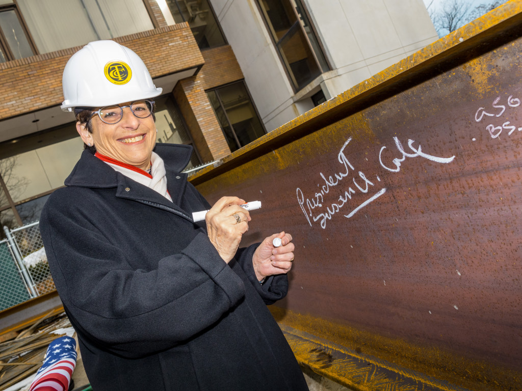 Cole writing name while wearing hard hat