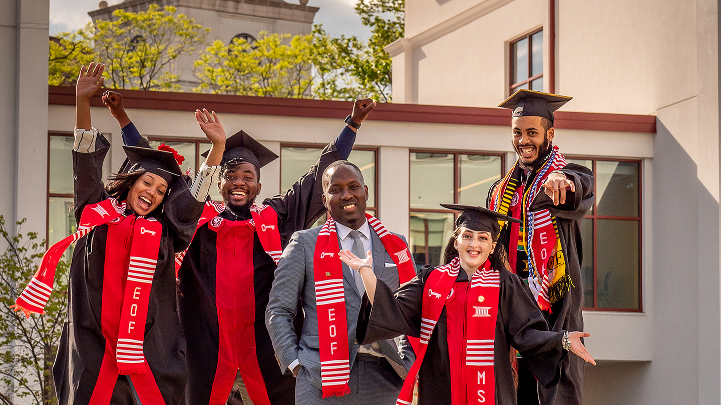 Assistant Provost Daniel Jean and graduating students