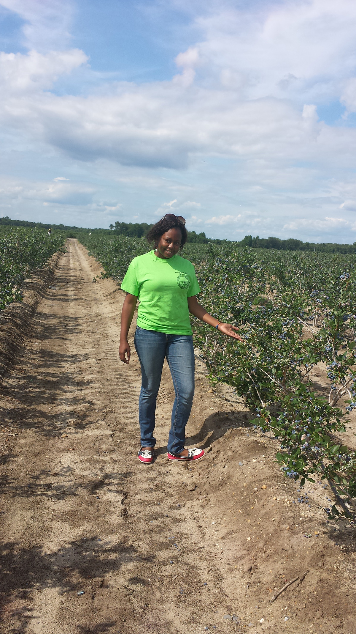 Guerline Pierre in a blueberry field