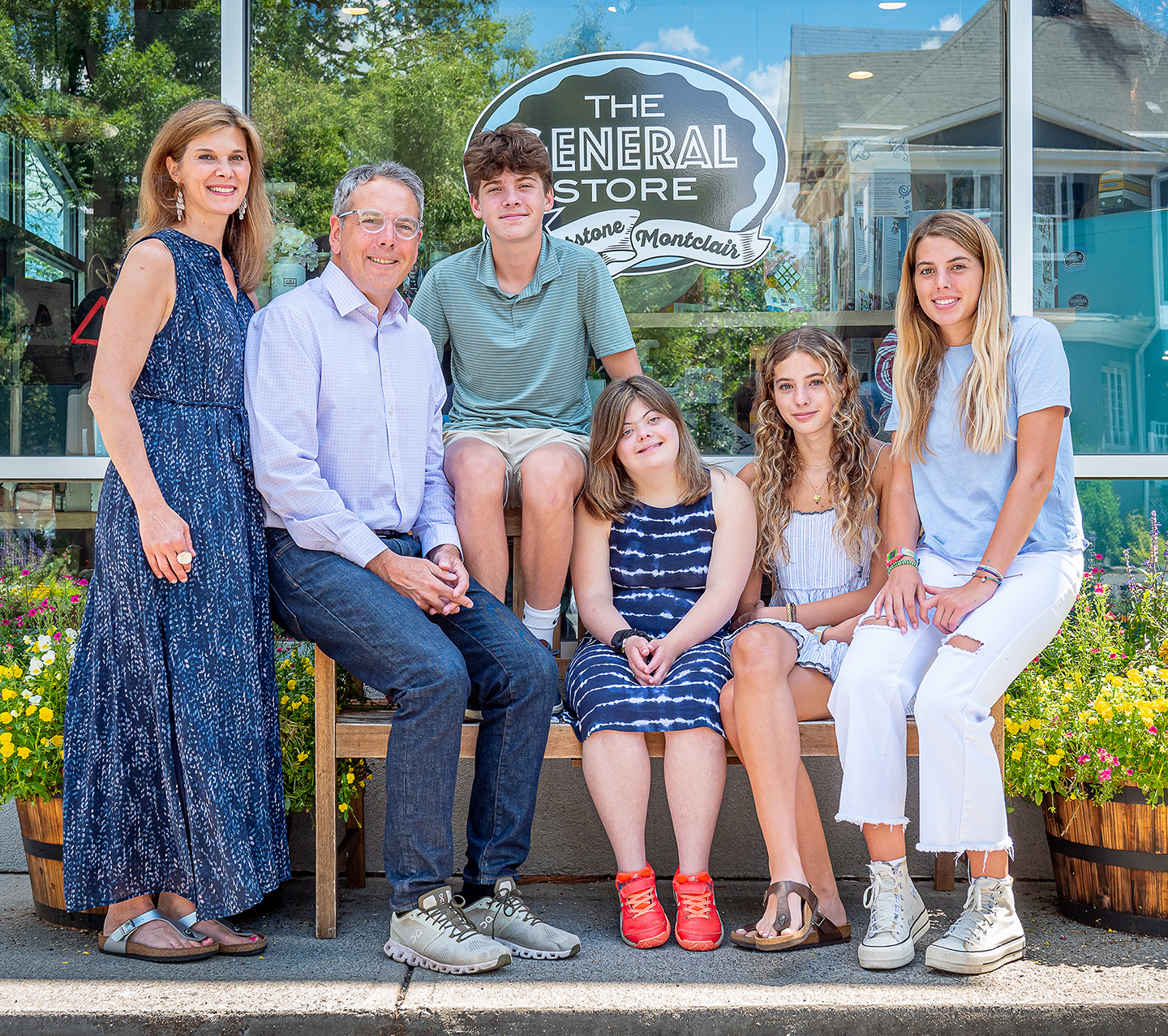 The Lacey family on a bench in front of the General Store