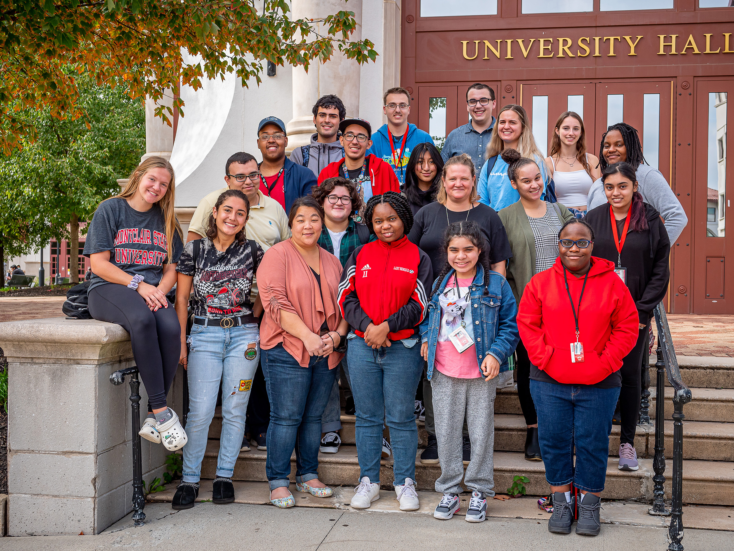 Volunteers and students in the Increasing Access to College project posing at the entrance to University Hall.