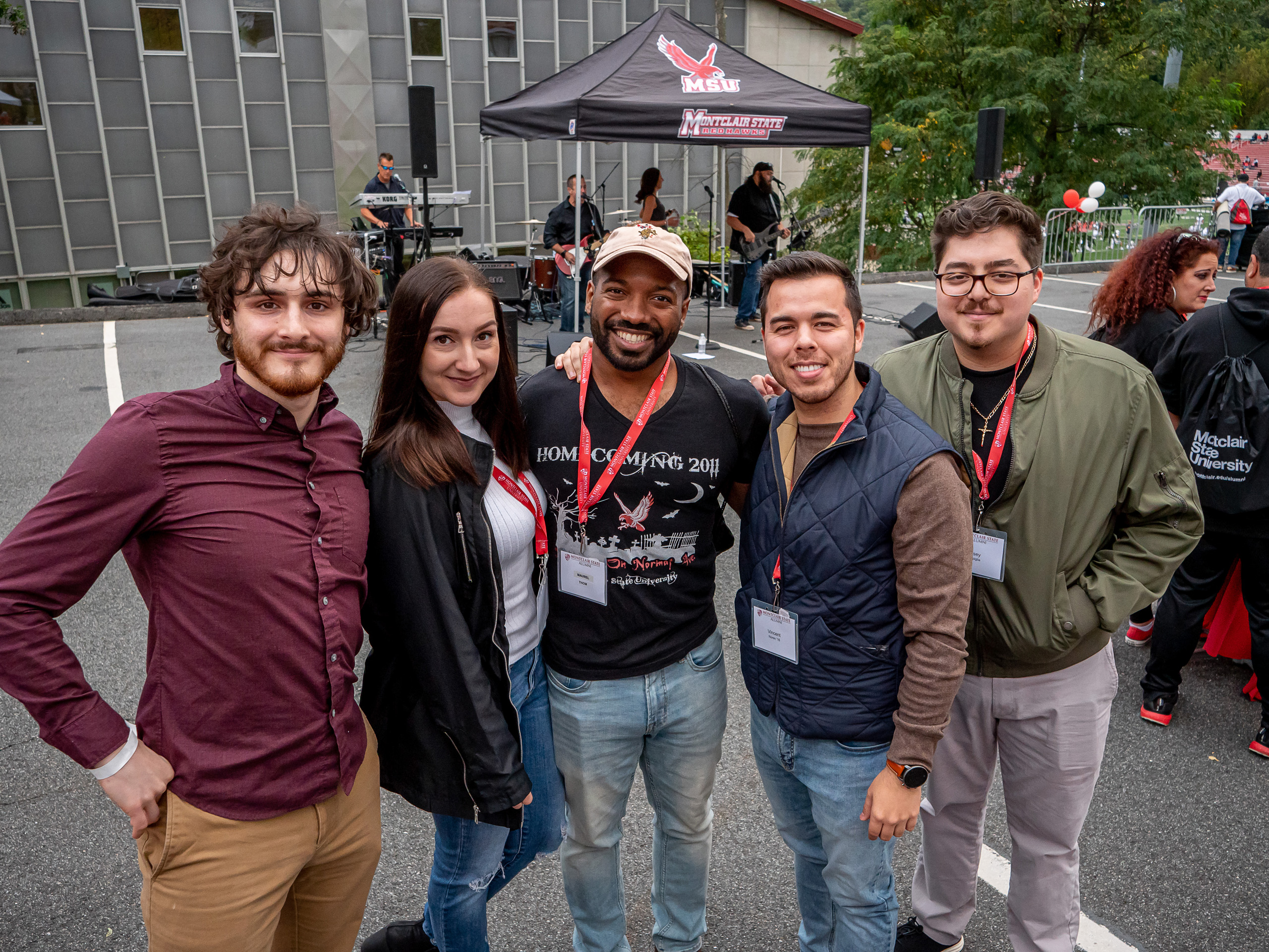 Five alumni smiling