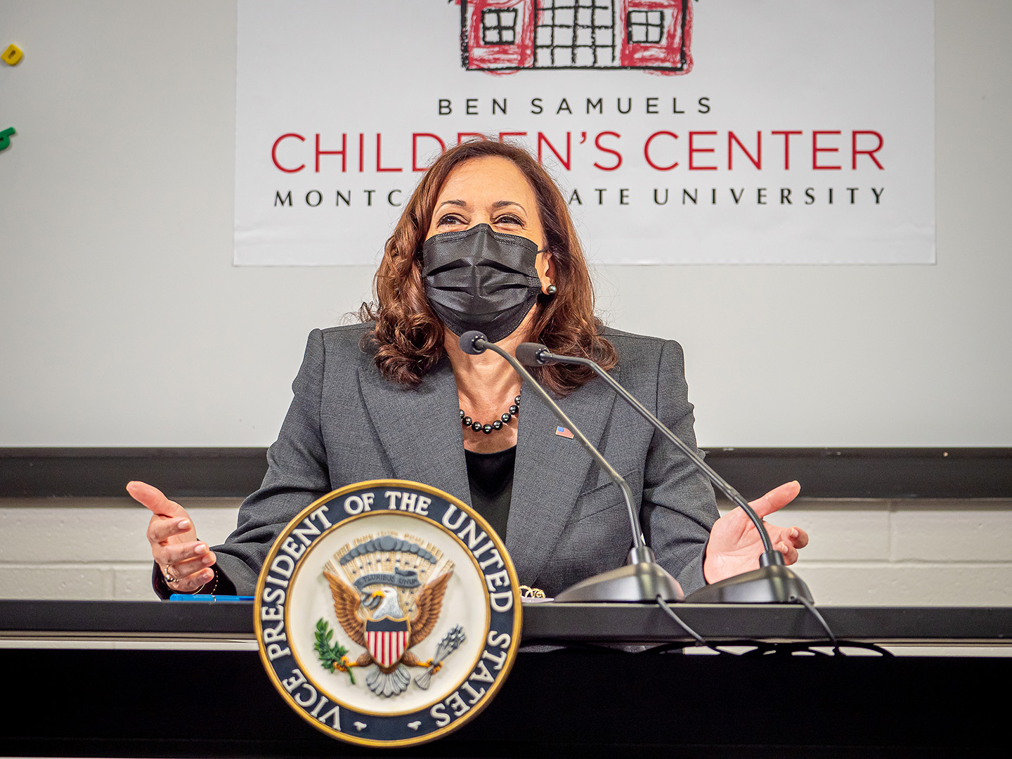 Vice President Kamala Harris seated at lectern