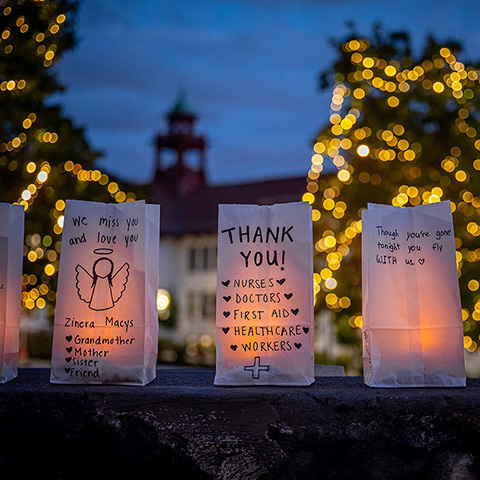 Lighted luminaria at dusk with messages by the MSU community