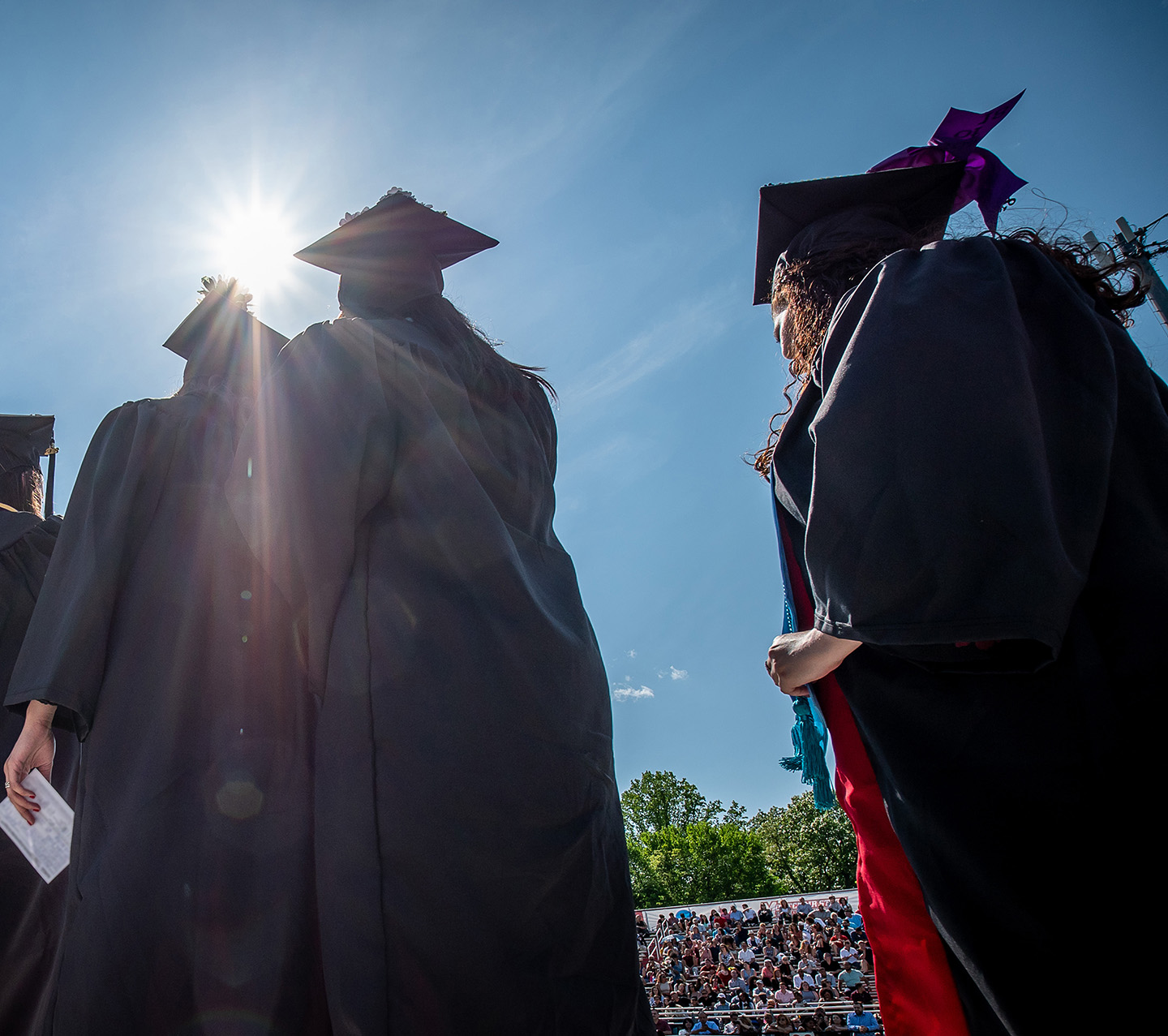 students walking in caps and gowns