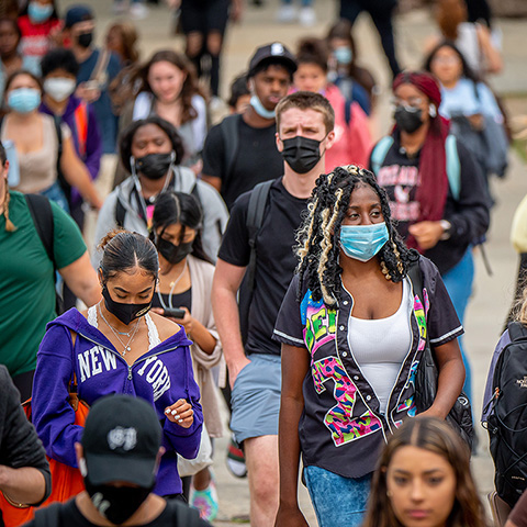 students wearing masks walking on campus