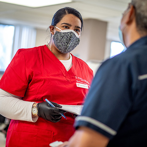 Nursing student speaking with patient