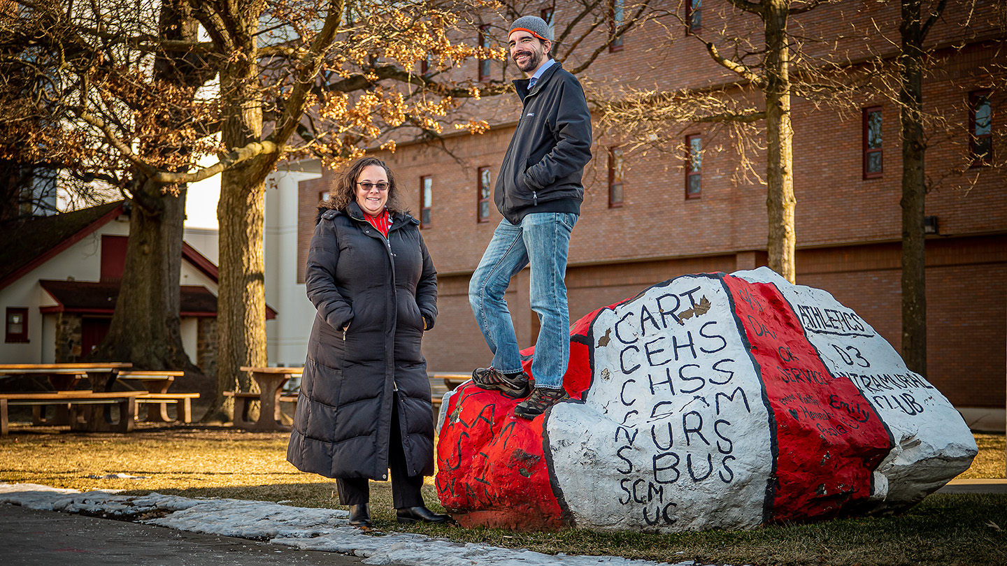 Julie Fleming and Anthony Mennuti pose with a painted rock