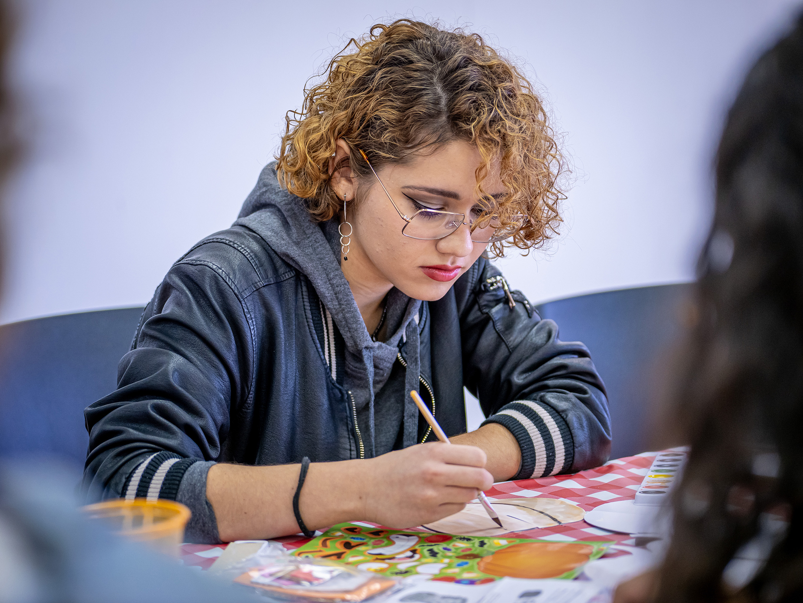 student coloring with pencil