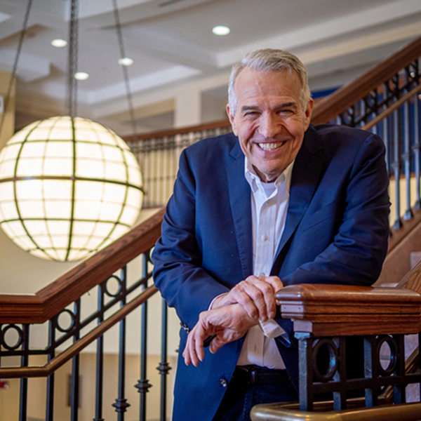 Rob Gilbert smiling on stairs