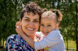 A young girl wrapping her arms around her mother