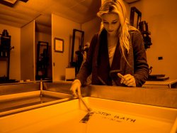 Photo of student using darkroom to develop prints.