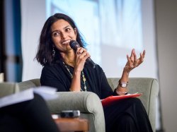Photo of guest author speaking to assembled students