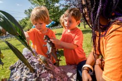 Photo of student talking with two young children.