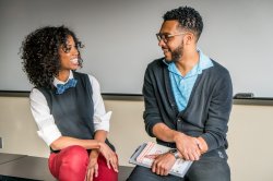 Photo of students practicing conversation in classroom