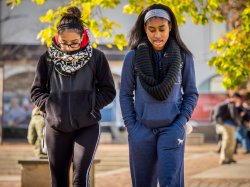 Photo of students walking across campus in late summer.