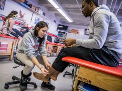 Photo of athletic training students assisting athletes.