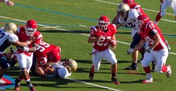 Montclair State football team executing a running play