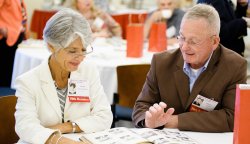 Photos of a pair of alums from the Class of 1967 at their 50th reunion reviewing yearbook.