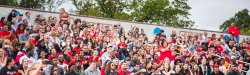 Crowd cheering at Montclair State University football game.