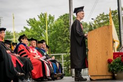 Graduate at poduium during commencement