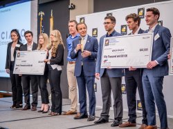 students with giant checks