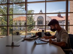 Student wearing mask using laptop