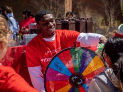 students lined up to spin a wheel for prizes