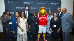 Rocky posing with President Koppell and Alumni