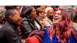 Student and alumna laughing in Kasser Theater