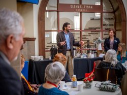President at coffee with reunion attendees