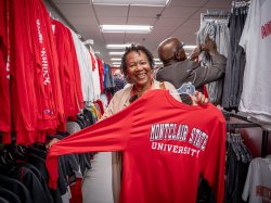 Woman holds up Montclair shirt.