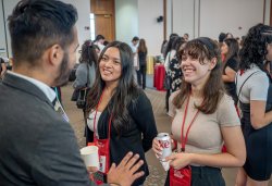 Students listening to an alum