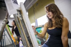 Students painting in art studio
