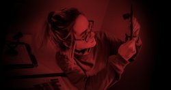 photo student examining photo exposure in darkroom